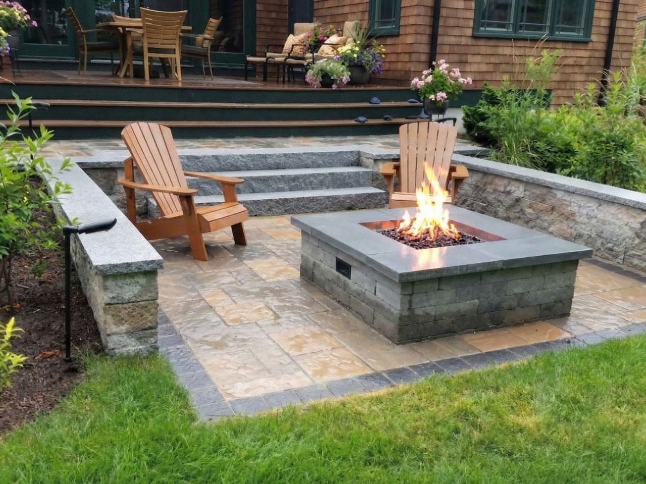 A square outdoor fireplace installed within a sitting area.