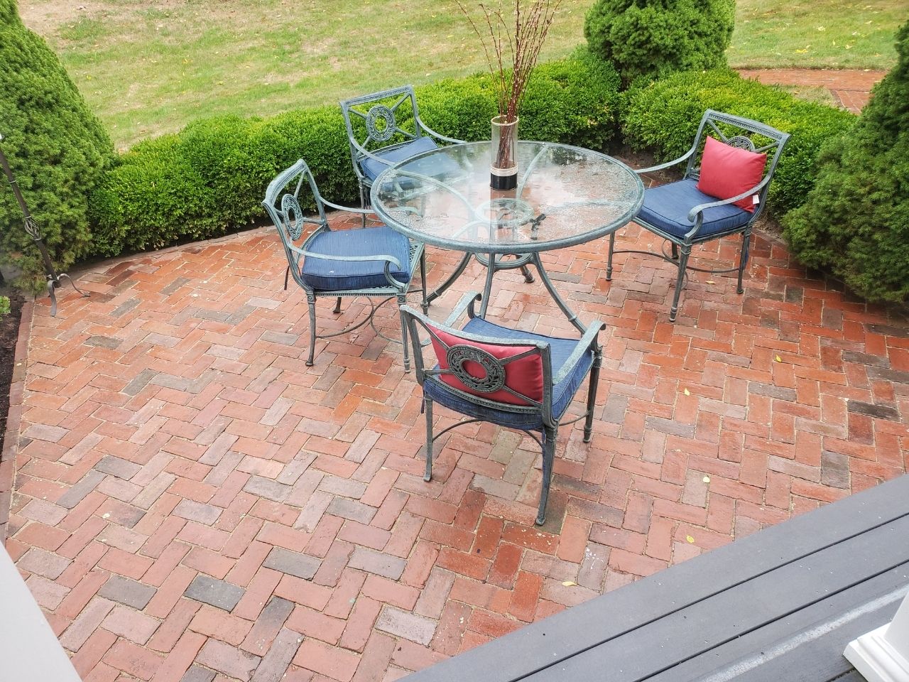 A square outdoor fireplace installed within a sitting area.